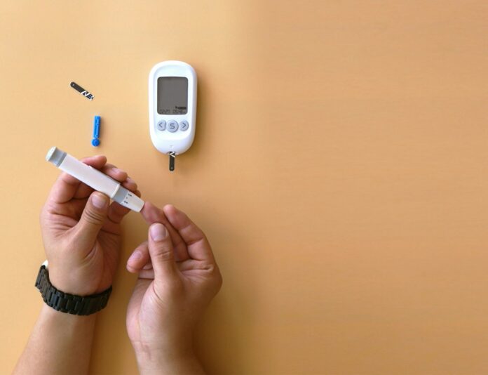 Photo by isens usa a person holding a thermometer next to an electronic device