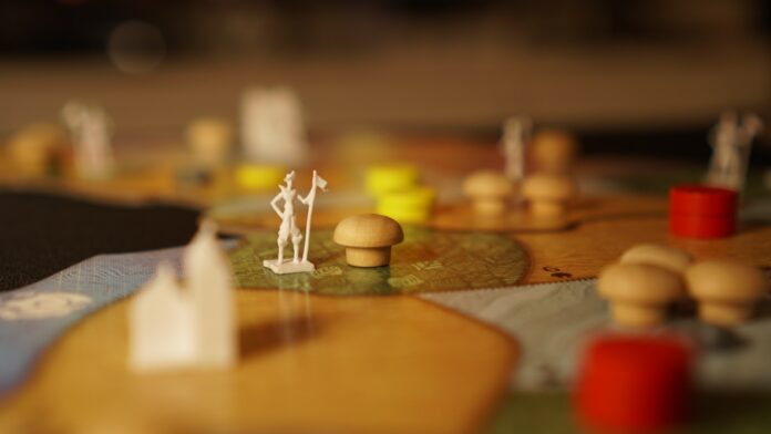 Photo by ibmoon Kim a close up of a board game with figurines on it