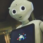 일상 속 건강 지킴이, AI가 알려주는 맞춤형 습관 white robot toy holding black tablet